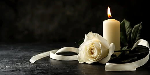 pngtree-white-roses-and-a-burning-candle-on-dark-background-funeral-display-image_16242602