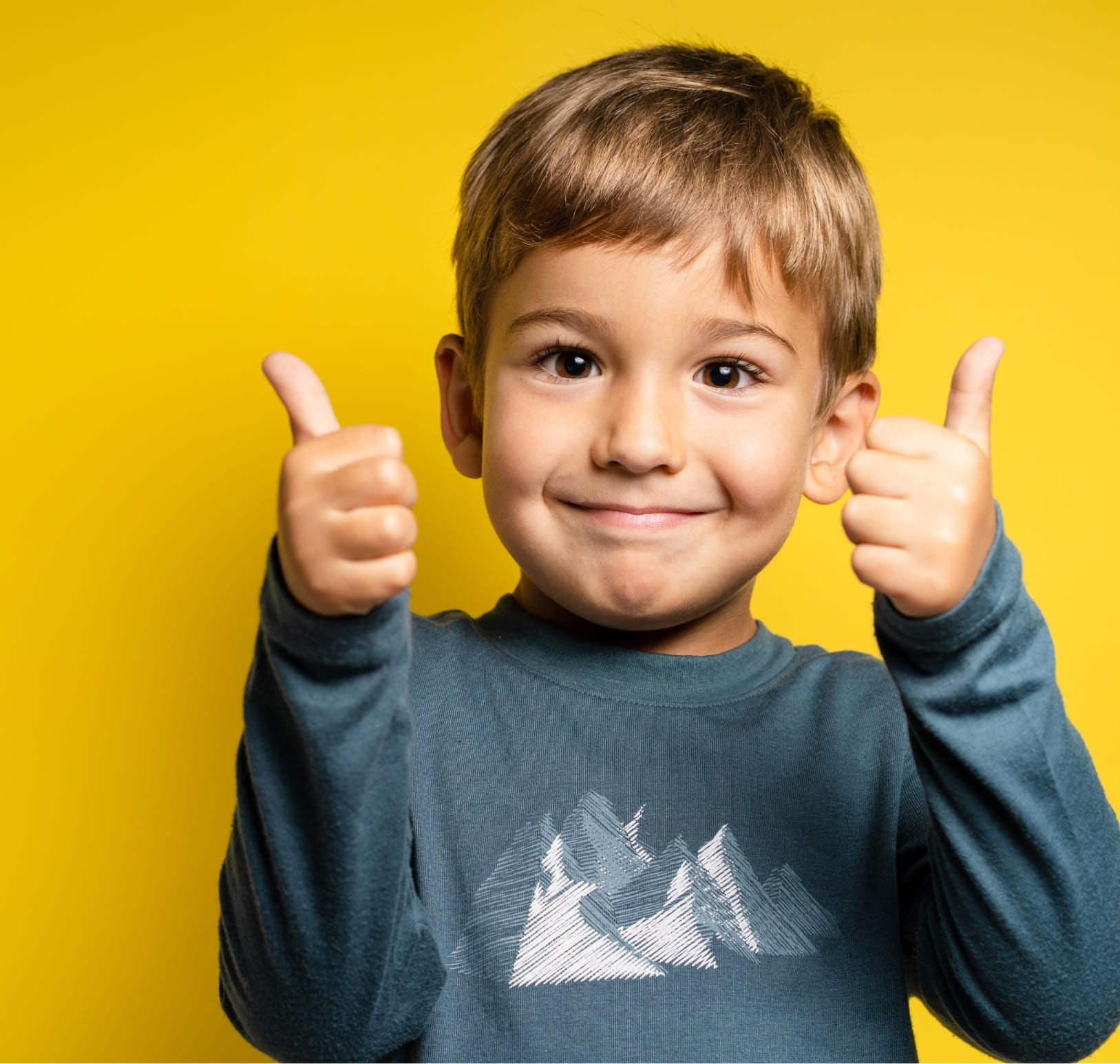 Young boy giving double thumbs-up